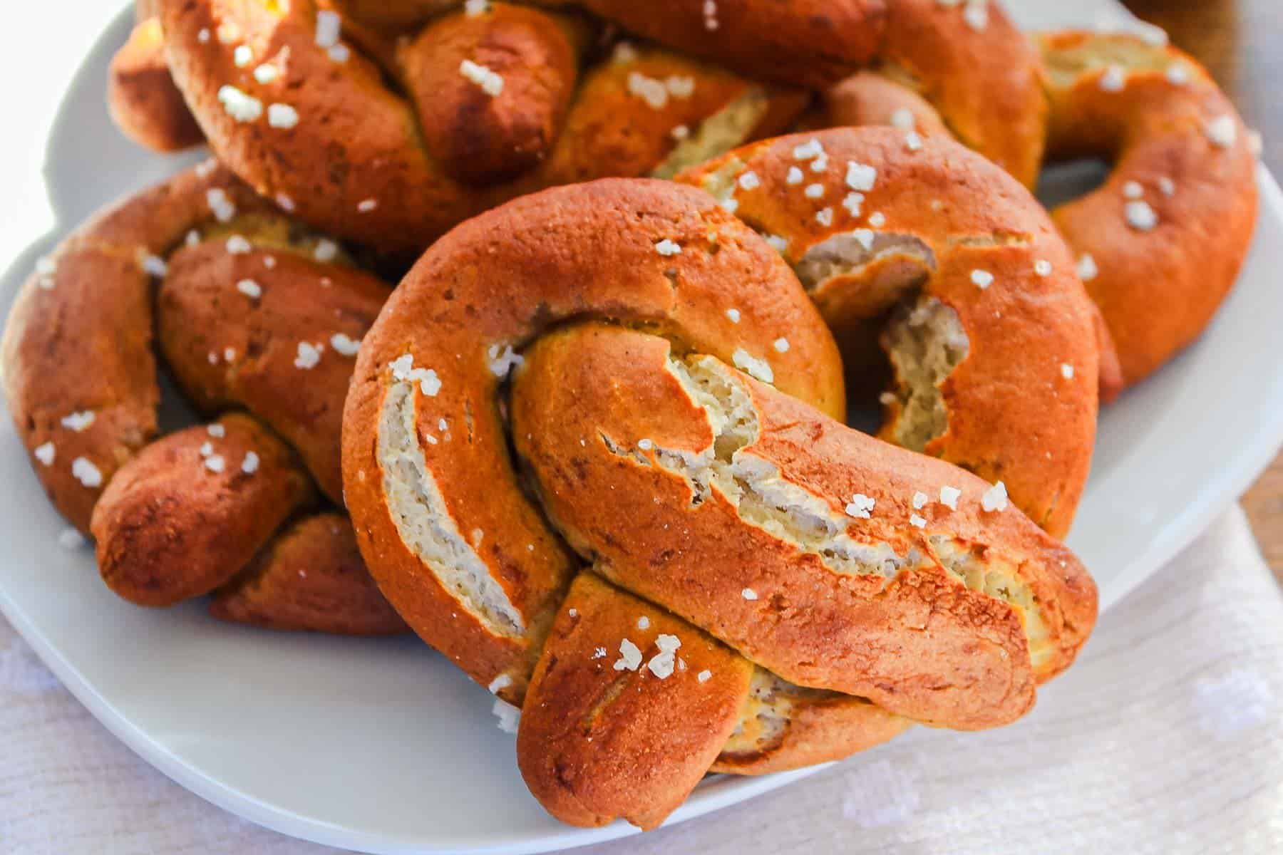 A plate of fresh Gluten-Free Soft Pretzels topped with coarse salt.