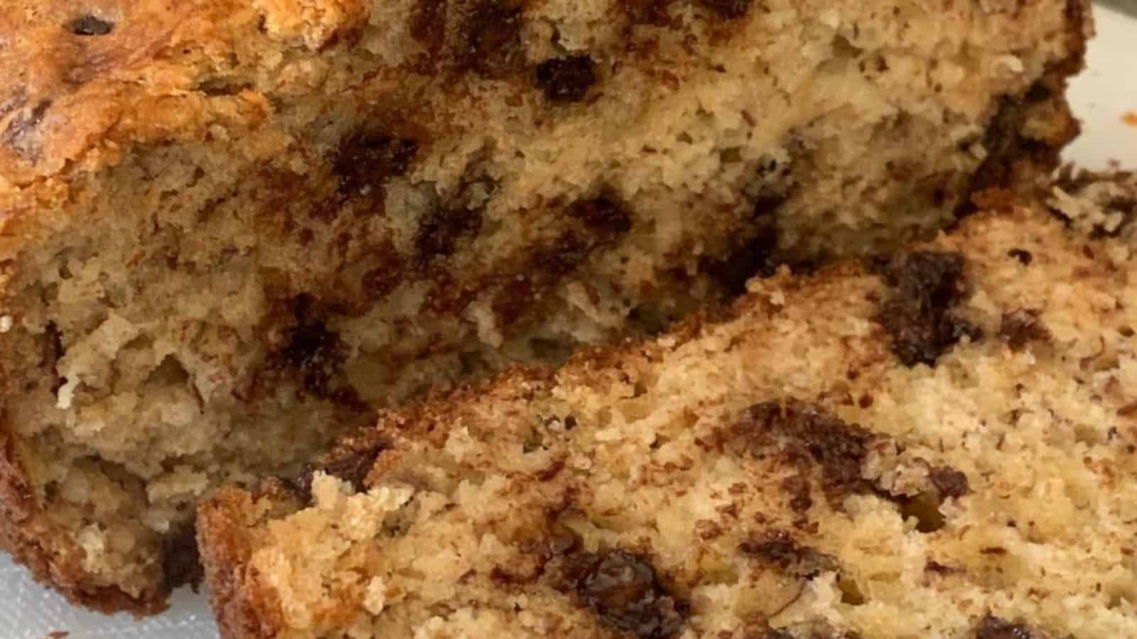 Close-up of sliced banana bread with chocolate chips visible throughout the moist, crumbly loaf.