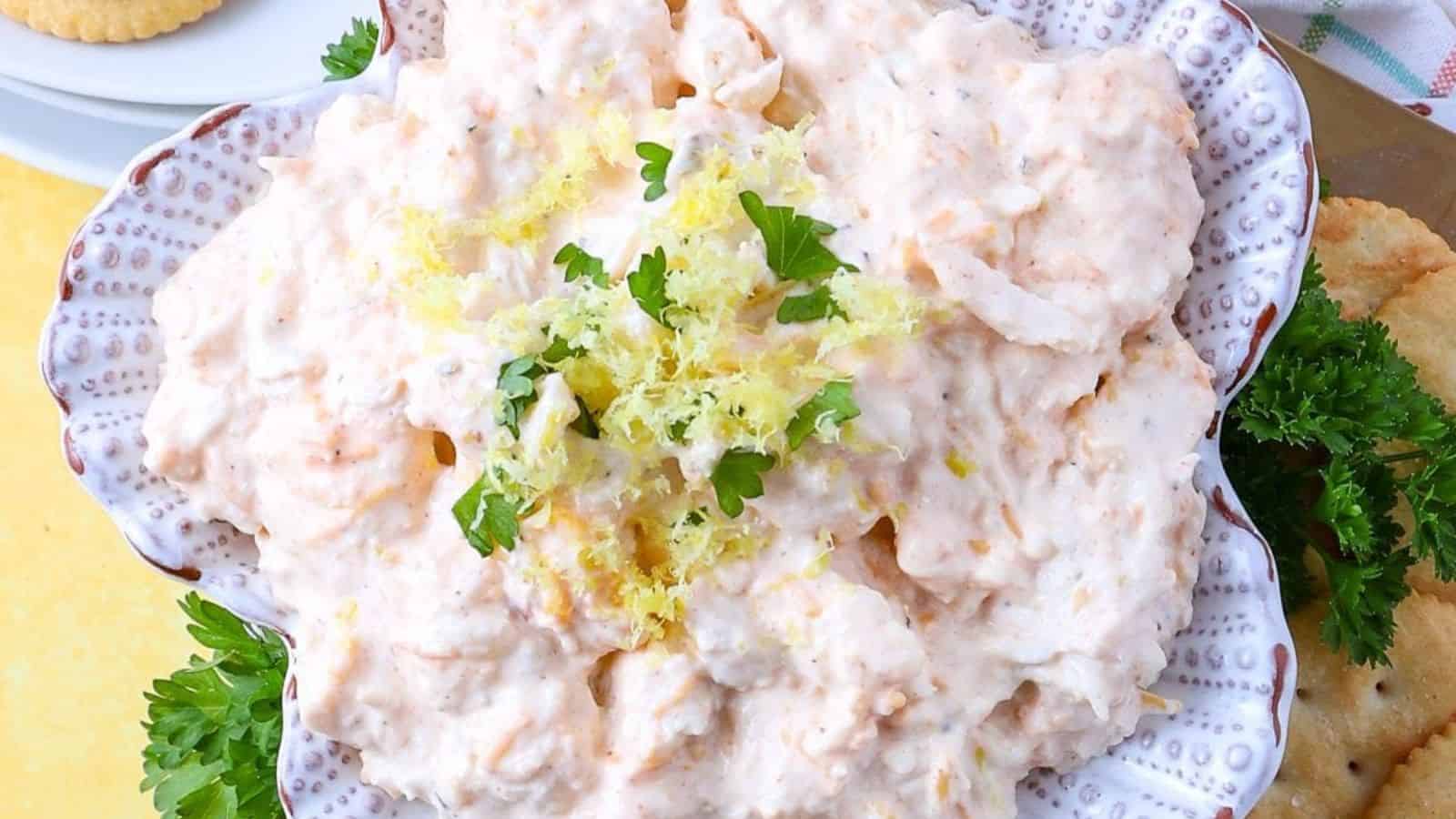 A bowl of cold crab dip with a creamy texture and chunks of crab.