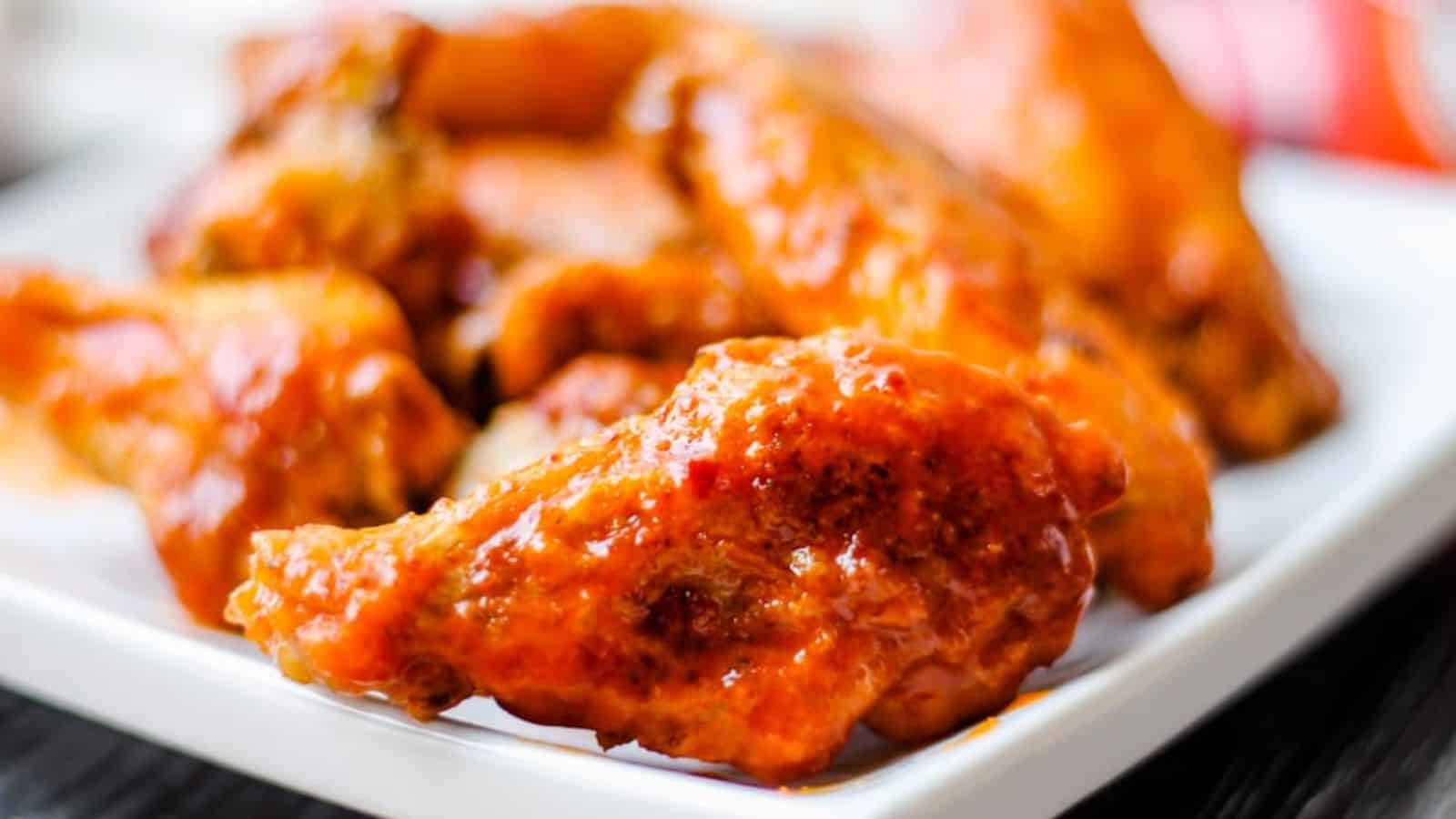 A plate of saucy Oven Baked Chicken Wings.