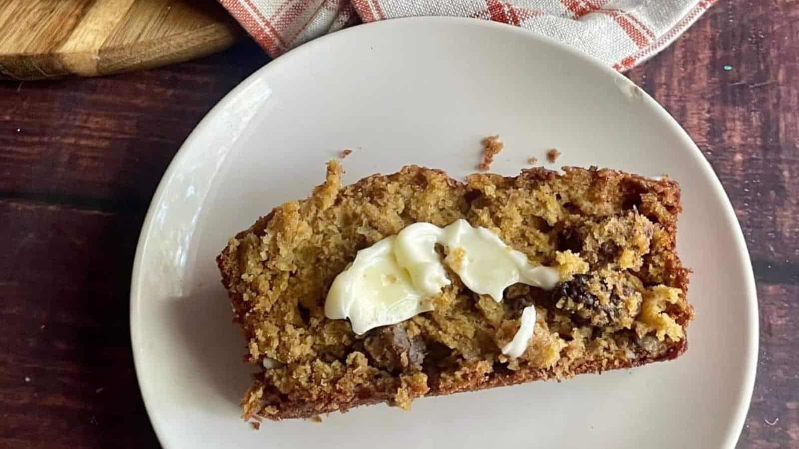A slice of pumpkin banana bread on a white plate.