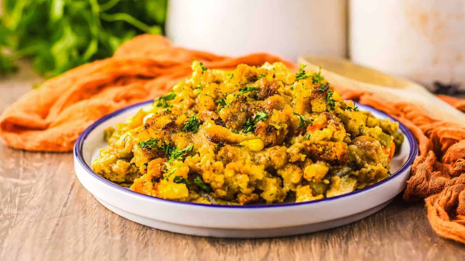 A spoonful of creamy chicken and stuffing casserole garnished with herbs.
