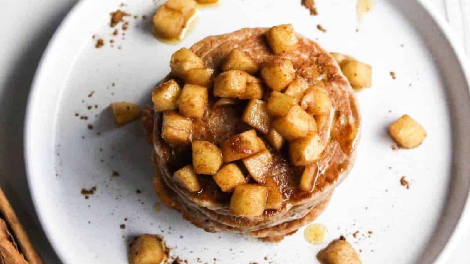 Cinnamon pancakes topped with cooked diced apples.
