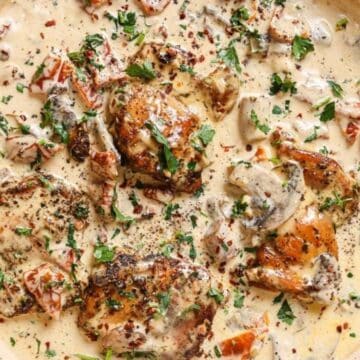 Chicken with creamy mushroom sauce in a pan.