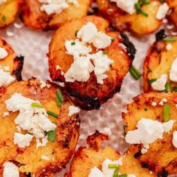 Crunchy roasted potatoes topped with feta cheese and fresh chives, perfect for an immigrant-inspired meal.