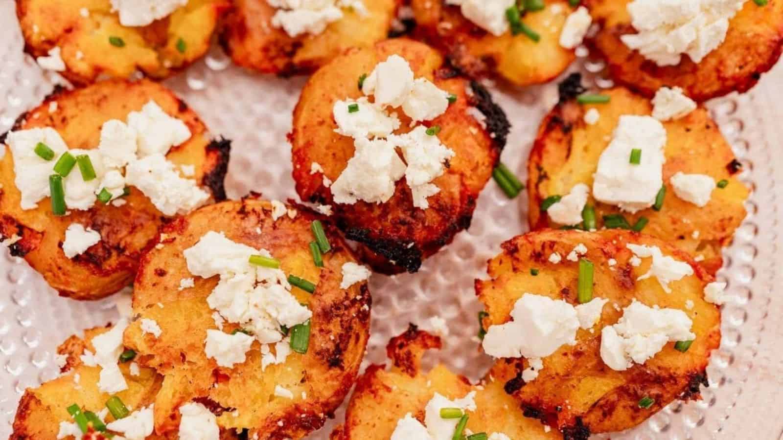 Crunchy roasted potatoes topped with feta cheese and fresh chives, perfect for an immigrant-inspired meal.