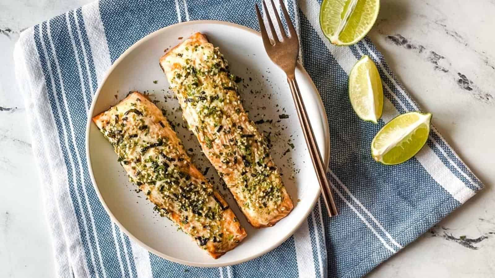 Two fillets of furikake salmon on a white plate.