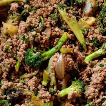 Ground beef cooked with broccoli, onions, and herbs, creating a savory and colorful stir-fry dish.
