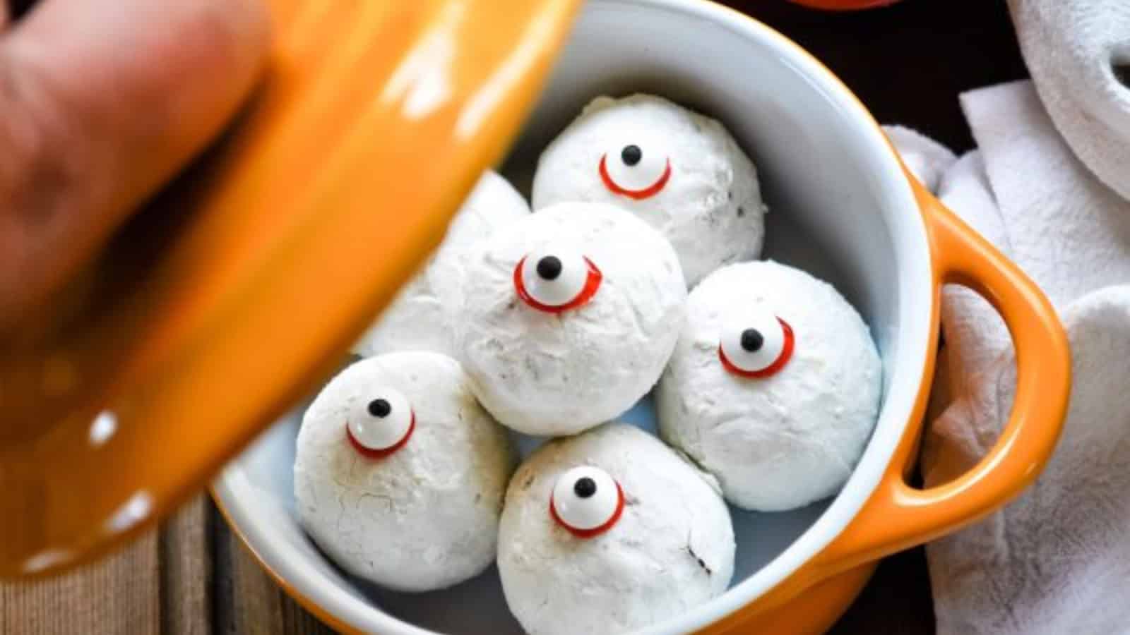 Doughnut holes with eyeball in an orange pot.