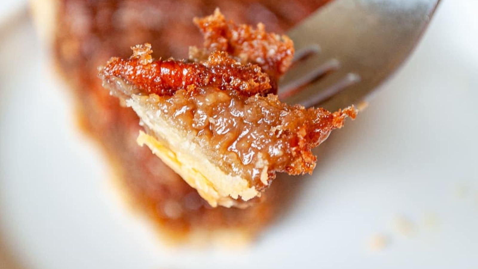 One slice of a maple pecan pie as seen from the side.