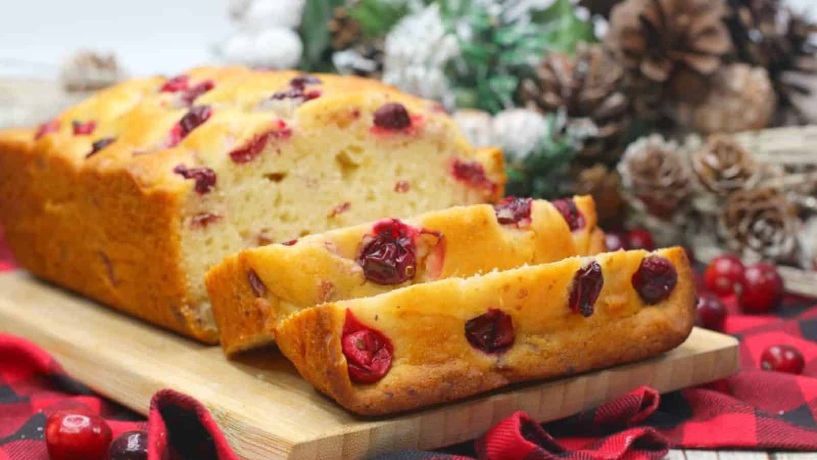 Sliced Orange Cranberry Loaf with holiday decor.