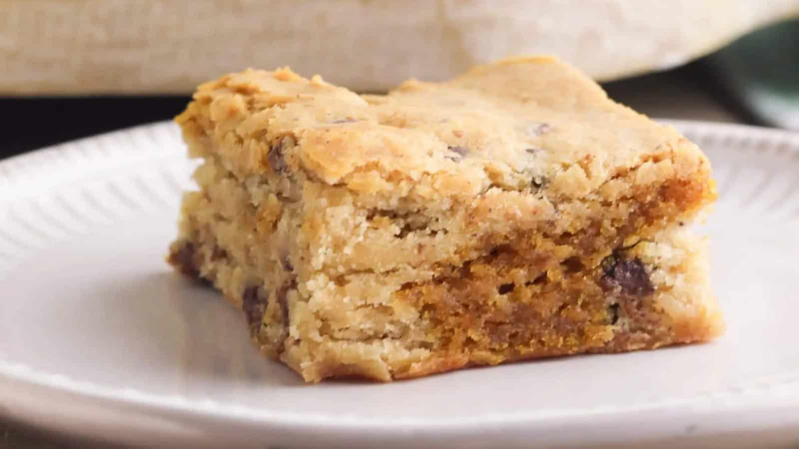 A pumpkin blondie is placed on a white plate.