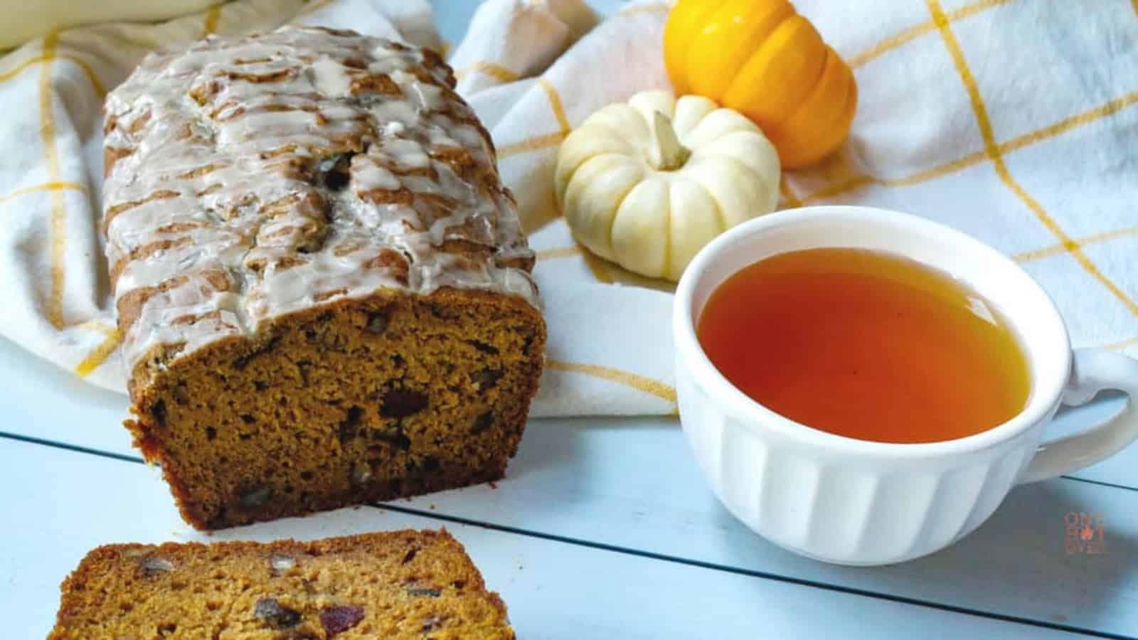 Iced pumpkin cranberry bread with a cup of tea.