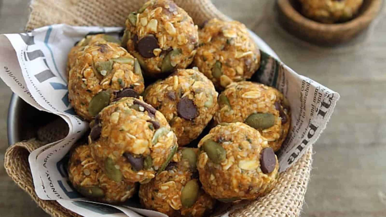 Pumpkin spice chocolate chip bites in a small bowl with newspaper and burlap.