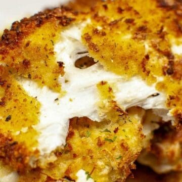 Close-up of golden, crispy roasted cauliflower steak with a crunchy breadcrumb coating.