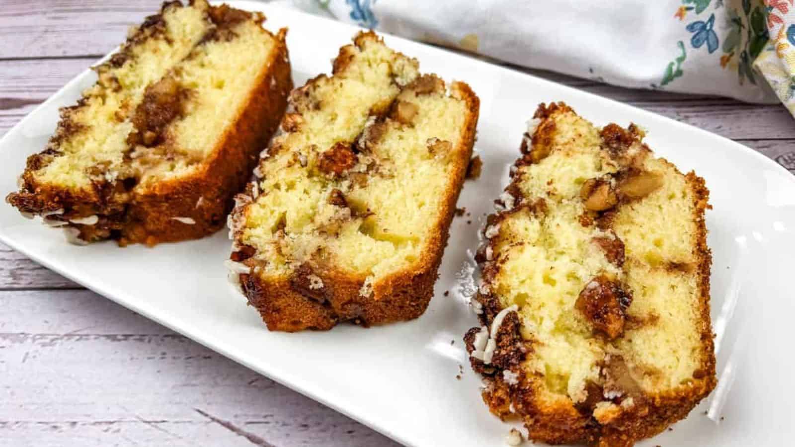 Three slices of apple fritter bread on a white plate.