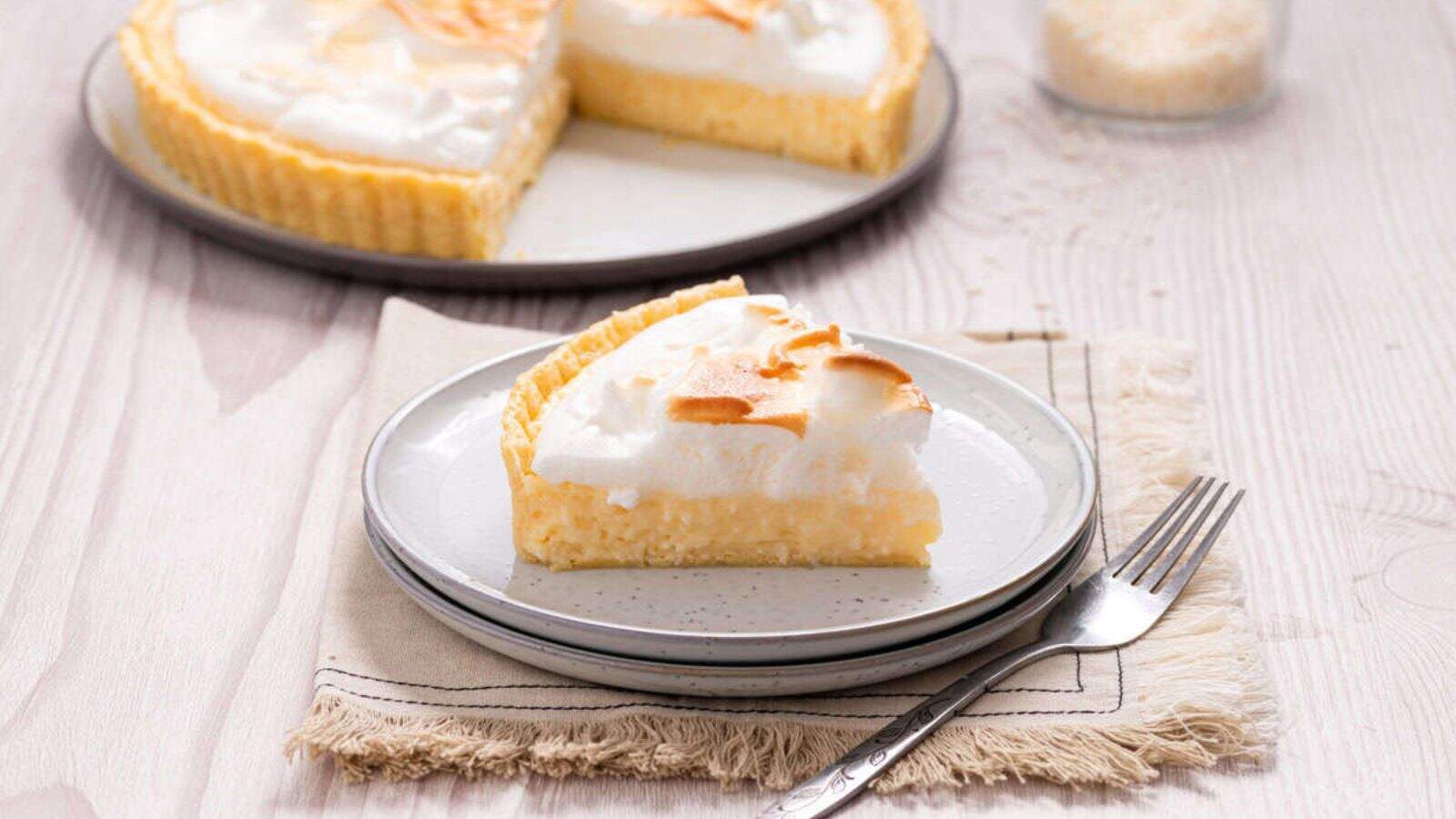 An image of a slice of coconut cream pie on a plate.