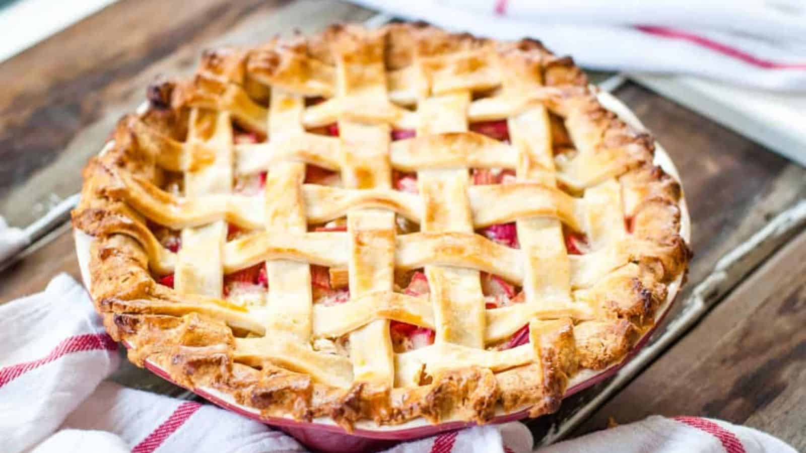 Rhubarb custard pie in a teal baking dish.