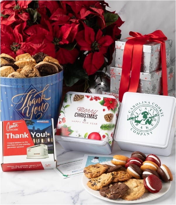 Assorted cookies and tins with thank you and Christmas messages, perfect as cozy holiday gifts, displayed in front of a poinsettia and wrapped gifts.
