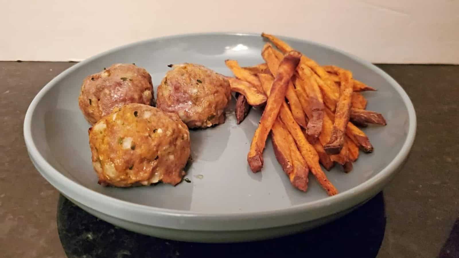Image shows a baking sheet with a raised tray holding Sweet Potato Turkey Meatballs.