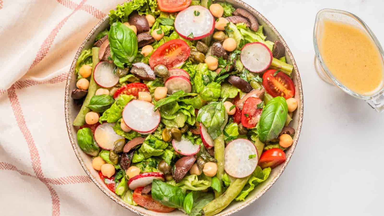 An image of vegan nicoise salad served on a big bowl.