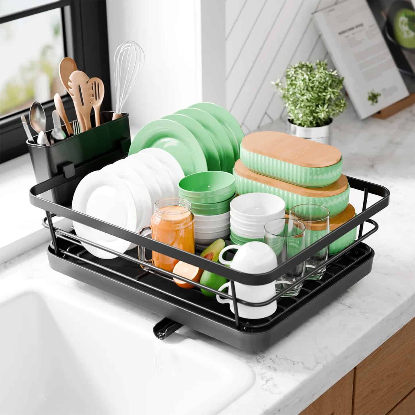 A dish rack with clean plates, cups, glasses, utensils, and sponges drying by the sink—one of those gifts that make holiday cleanup easier.