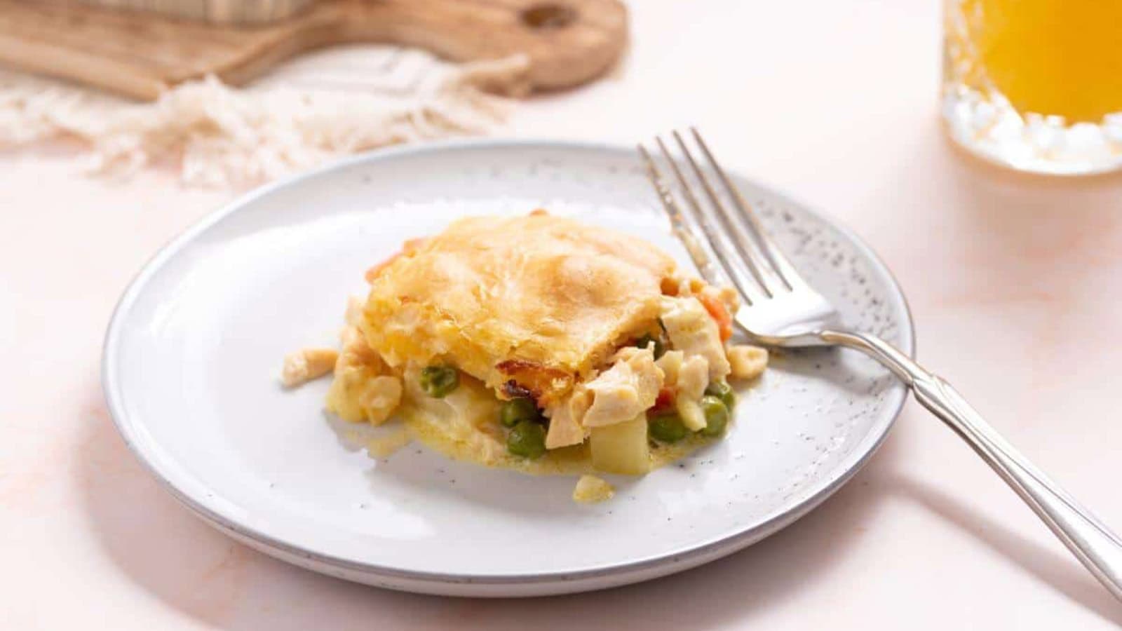 Small serving of chicken pot pie casserole on plate with fork.