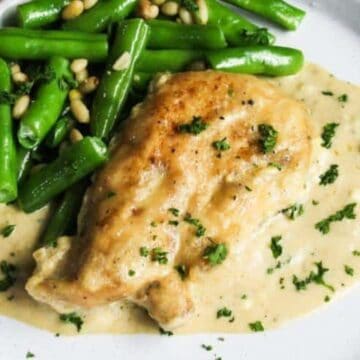 A plate of food with a sauce and beans.