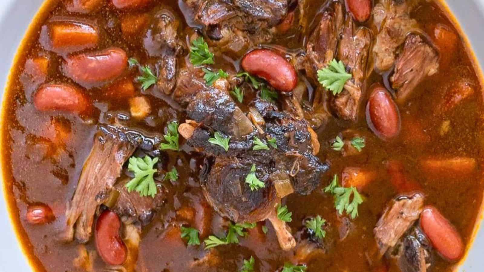 A close-up of beef and kidney bean stew garnished with fresh parsley.