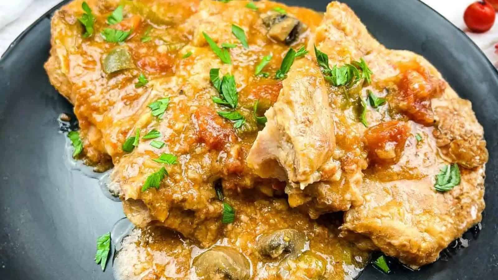 Slow Cooker Swiss Pork Chops on a baby blue serving dish.