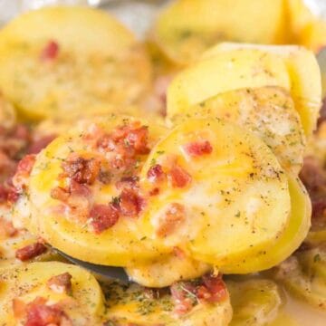Sliced potatoes baked with melted cheese, bacon bits, and herbs, served on a spatula—these simple sides are perfect for any meal.
