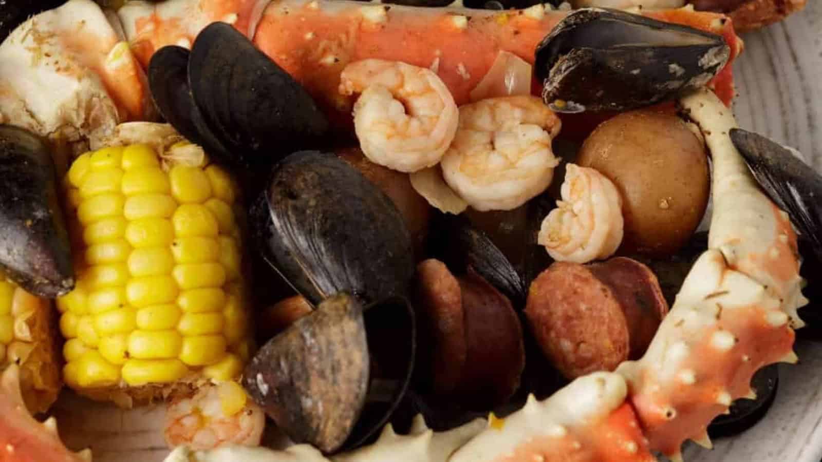 Southern seafood boil with shrimp, corn, potatoes, and sausage spread across a table.