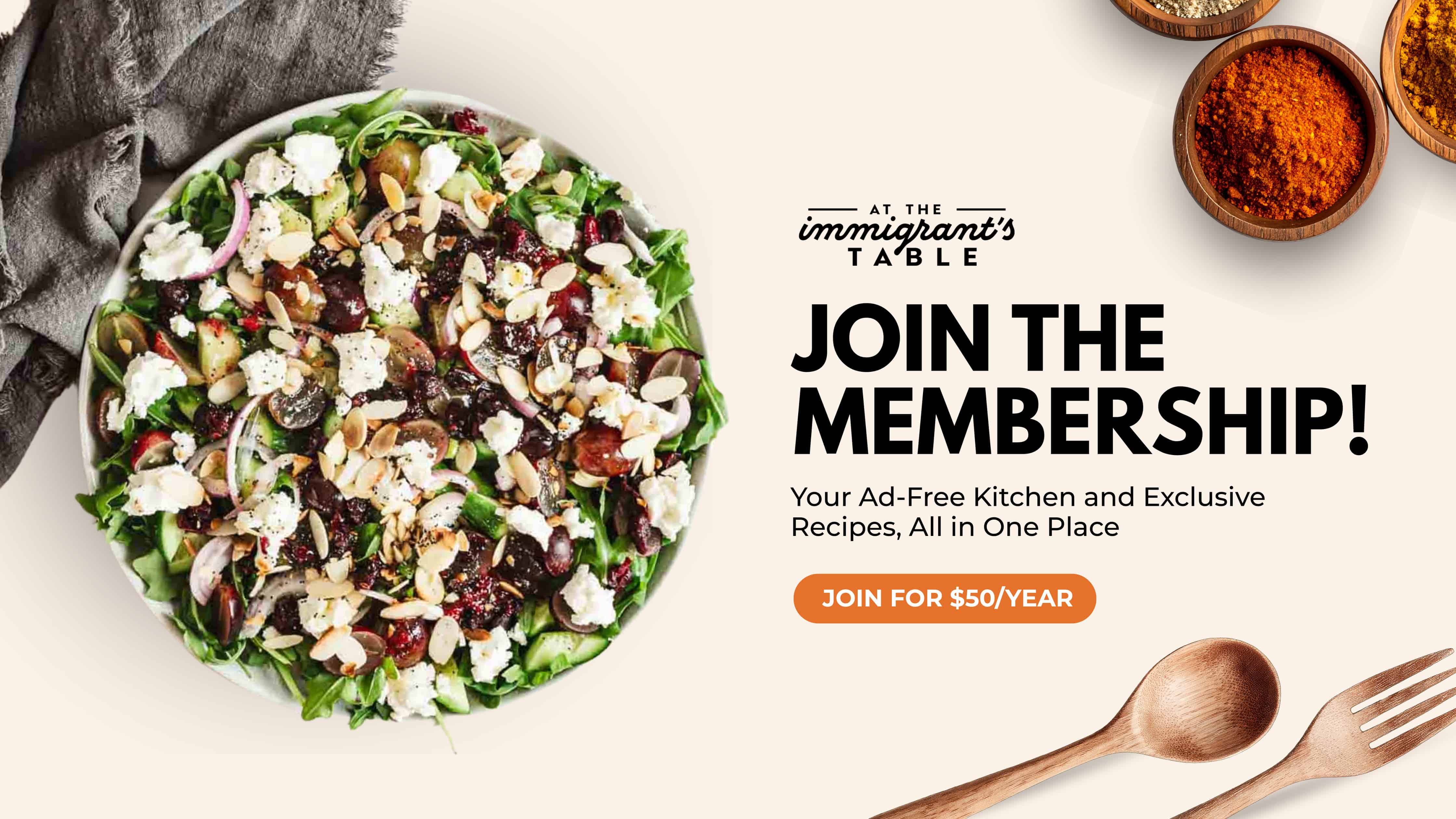 A salad in a bowl next to text promoting a recipe membership for $50 per year, with wooden utensils nearby.
