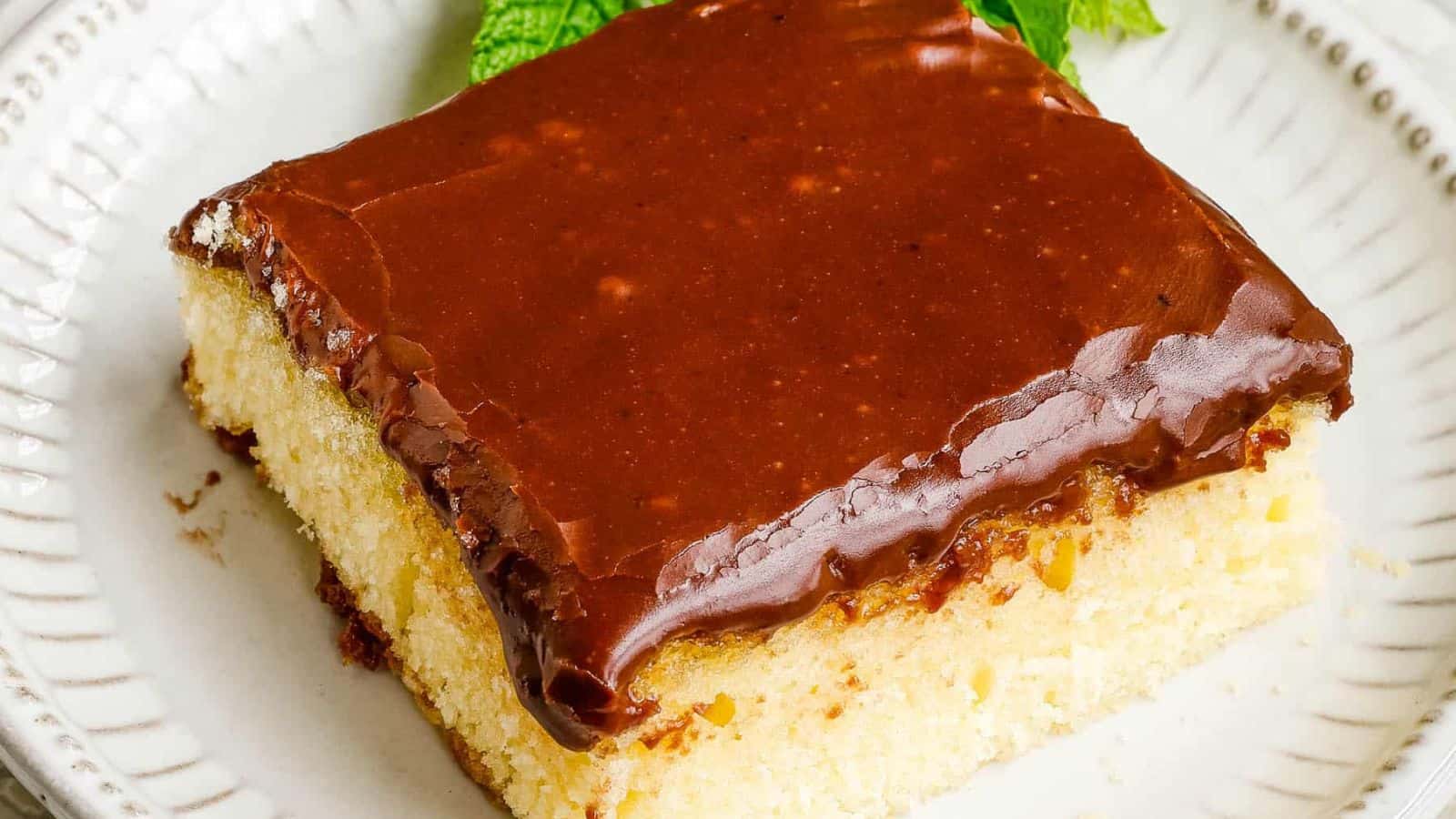 Flat lay of square hot milk cake on plate.