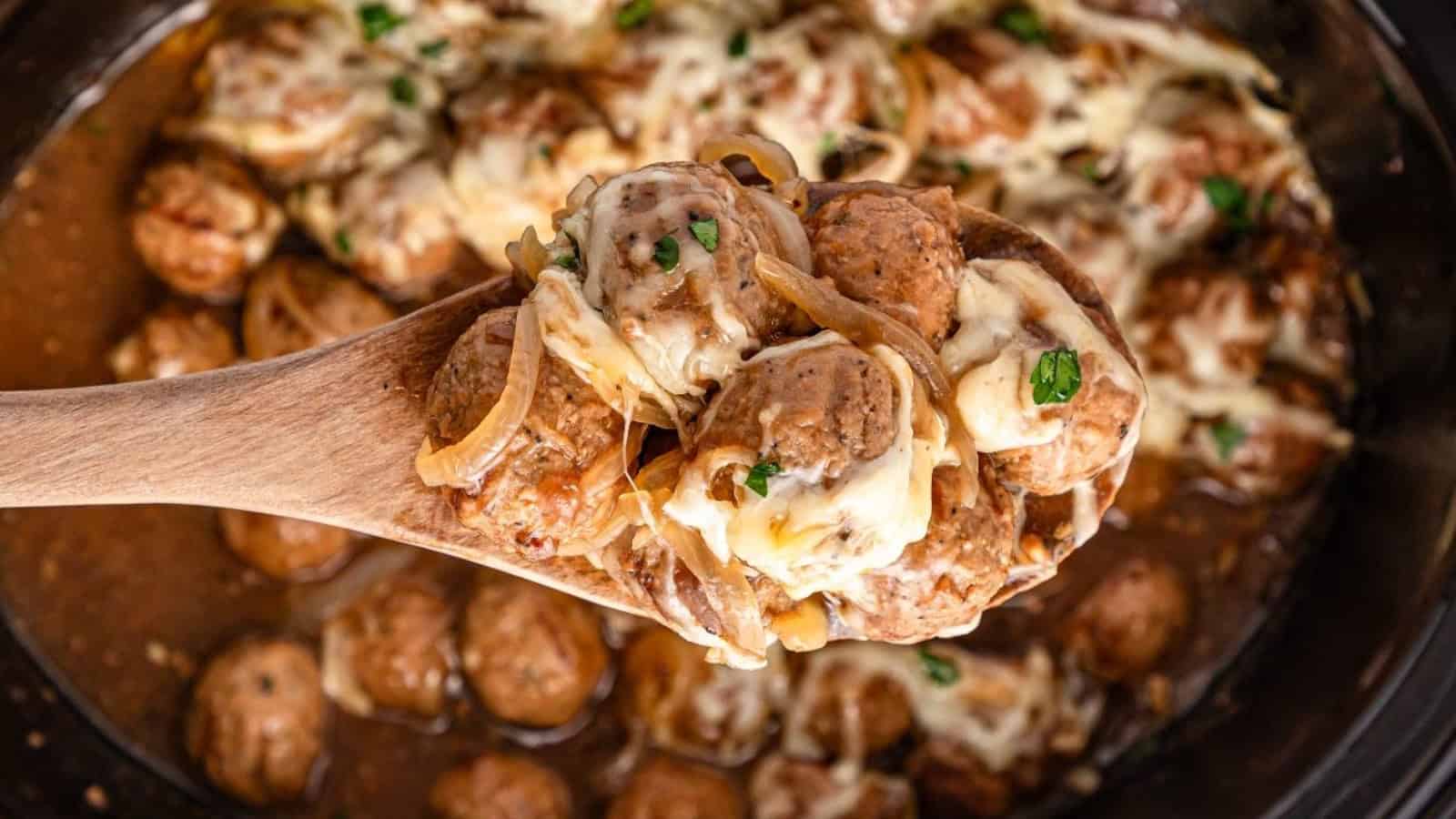 Meatballs in gravy with onions on mashed potatoes, garnished with parsley, served with toasted bread slices.