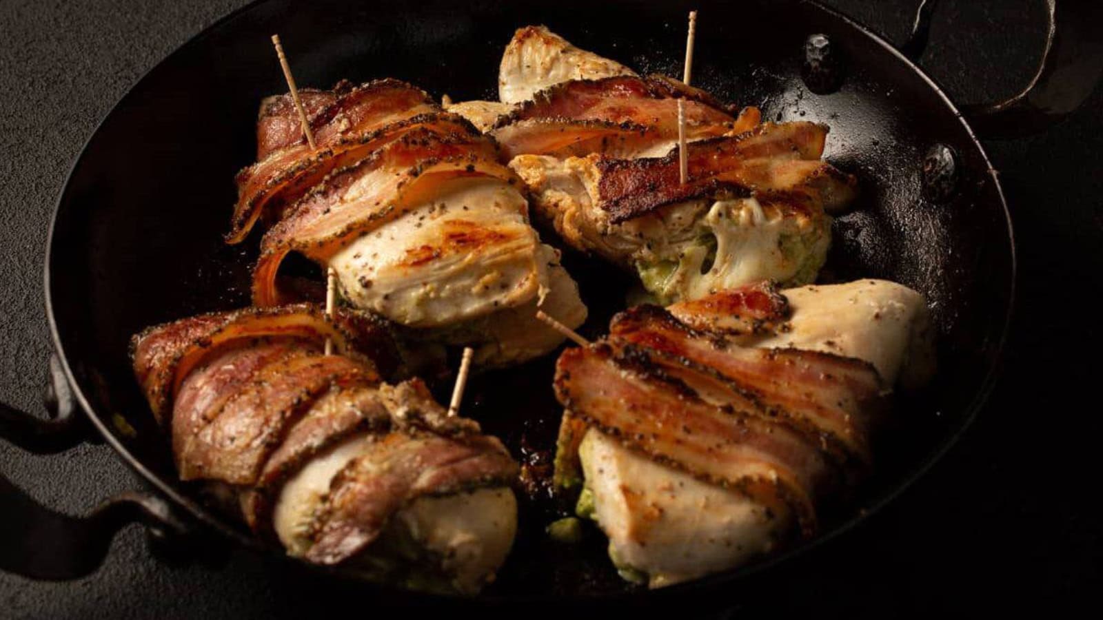 Bacon-wrapped chicken topped with pesto and baked until crisp.