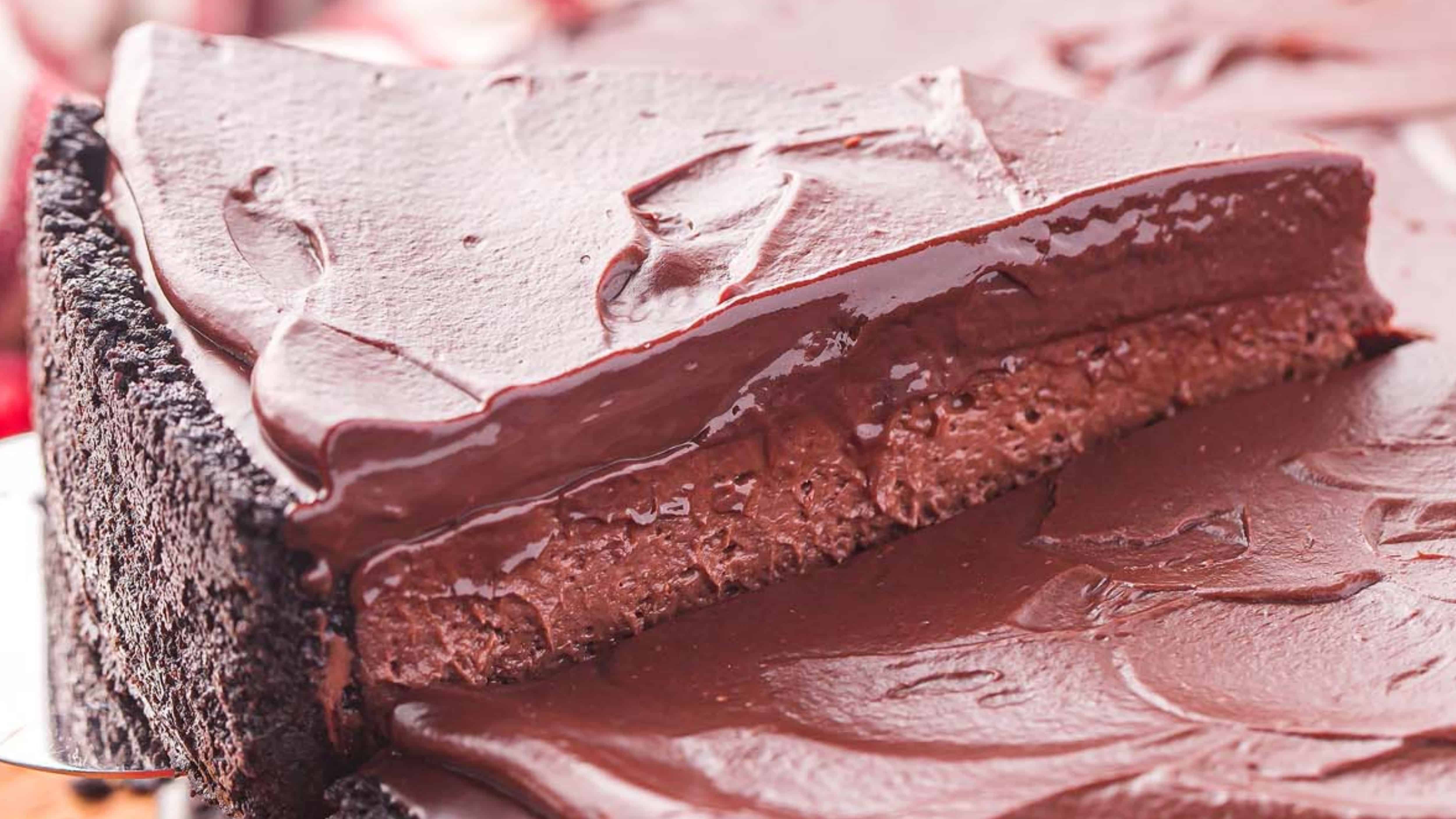 A close-up of a rich, creamy chocolate pie with a chocolate cookie crust and smooth chocolate topping.