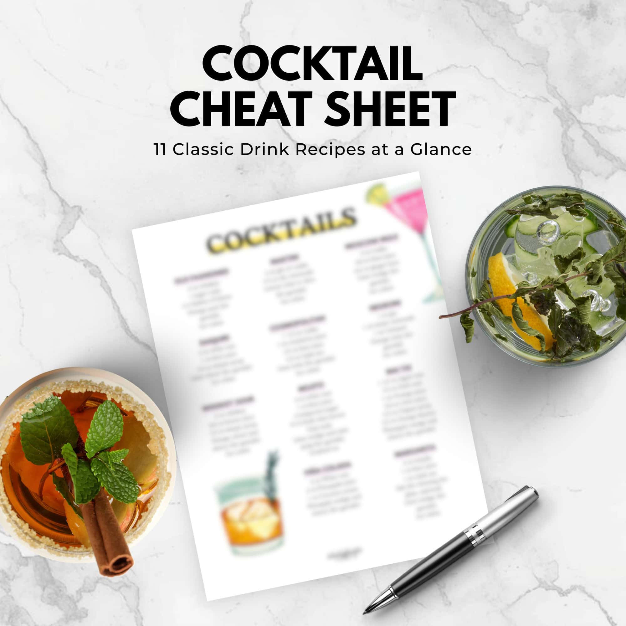 Flat lay of a cocktail cheat sheet, pen, mojito, and spiced drink on a marble surface-perfect for inspiration from the immigrantstable shop.