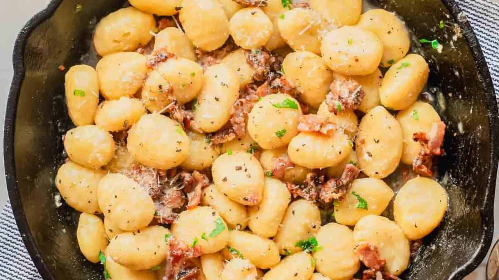 Gnocchi carbonara in creamy sauce with bacon and herbs.