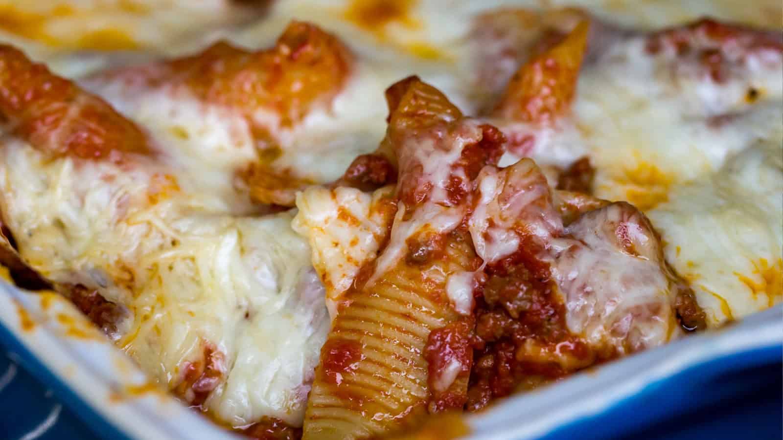 Baked stuffed pasta shells filled with cheese and topped with sauce.