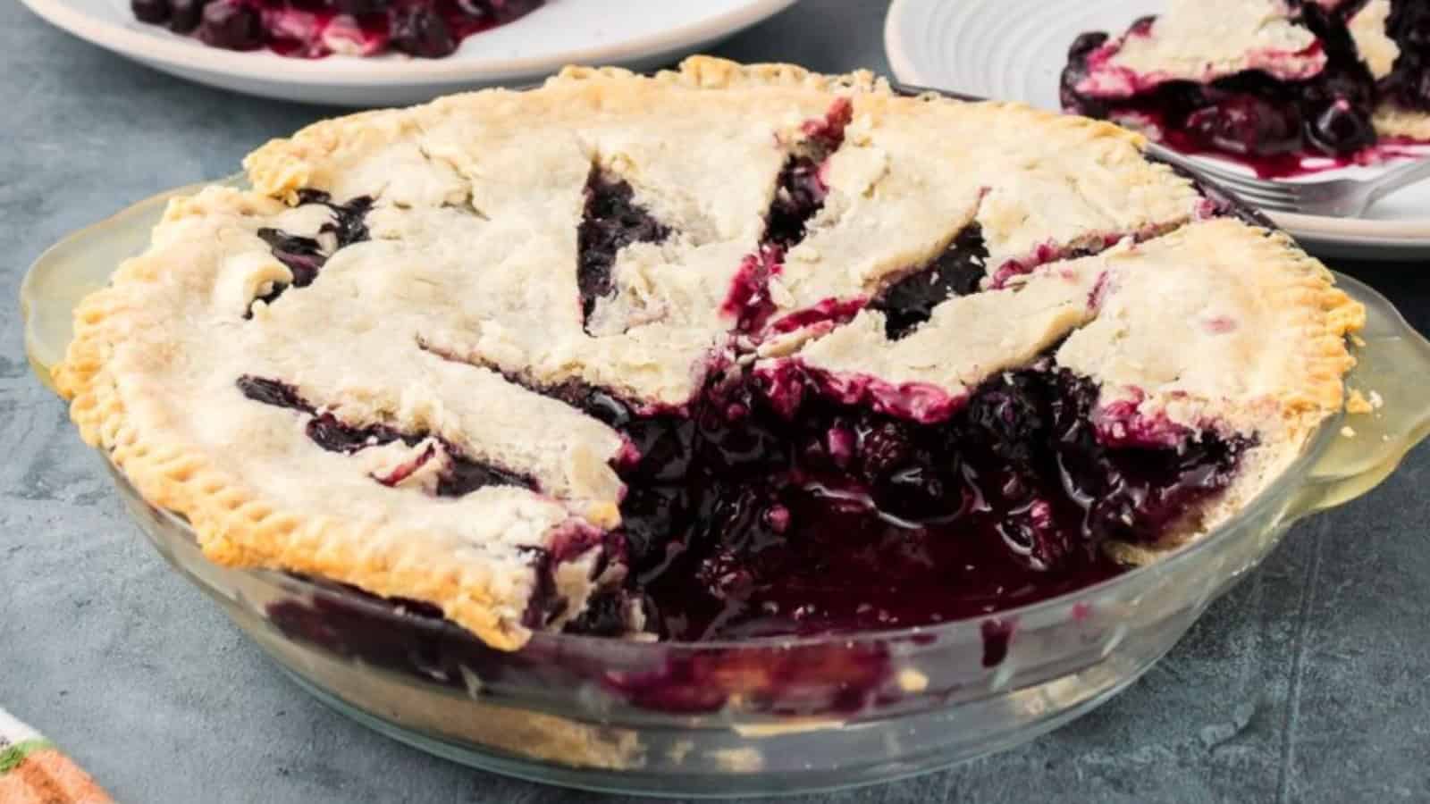A blueberry pie with a flaky crust, several slices removed, revealing the juicy filling inside&mdash;just like those classic grandma dishes everyone loves.