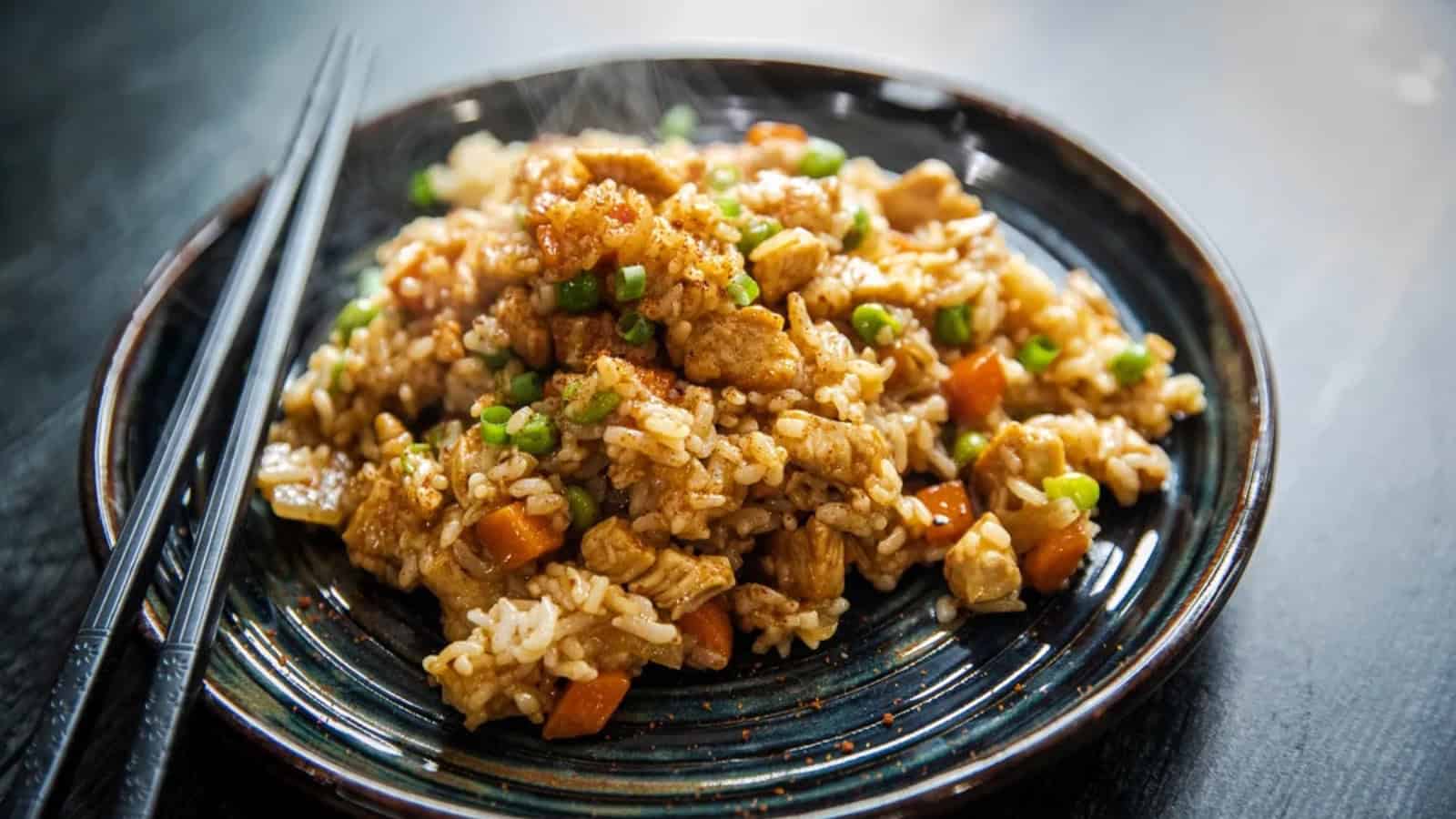Blackstone griddle chicken fried rice with chicken, rice, vegetables, and savory seasonings.