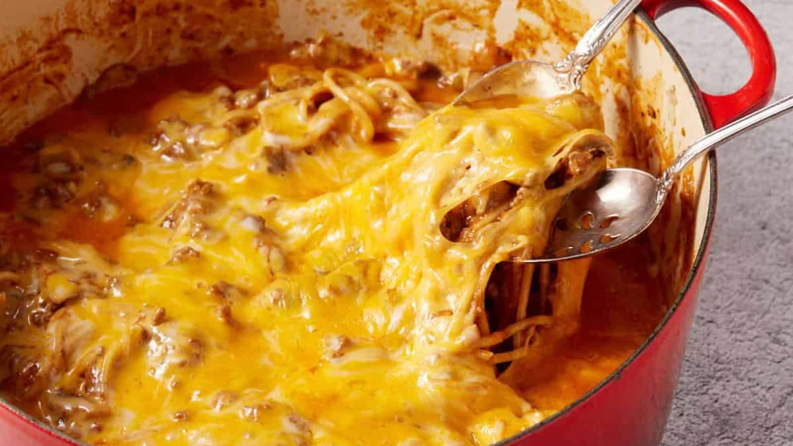 Cheesy spaghetti casserole with ground beef and melted cheese served from a baking dish.