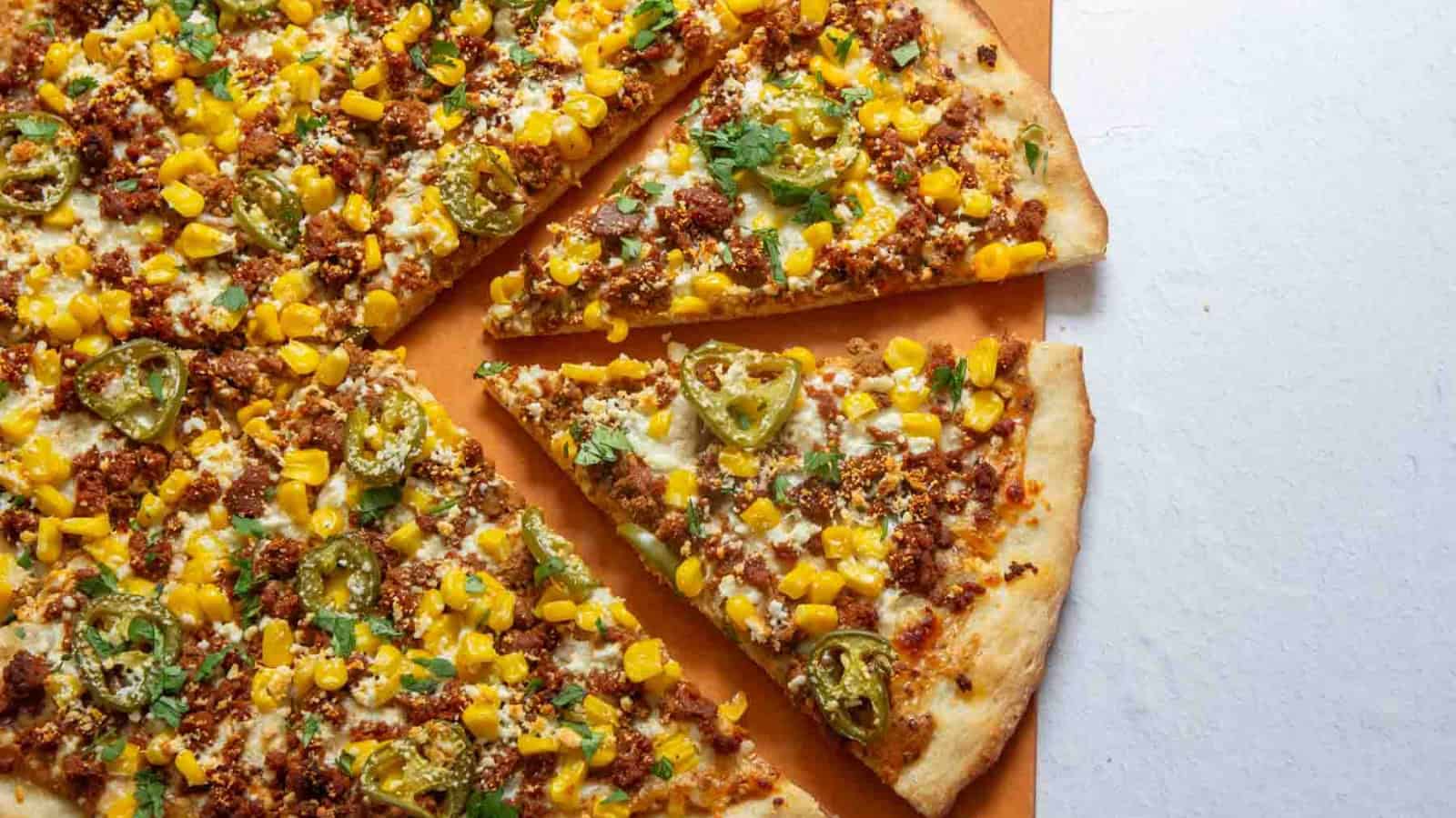 Mexican street corn pizza with corn, cheese, and herbs on a crispy crust.
