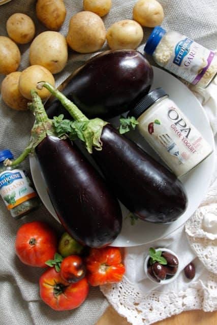 A lightened up version of a classic, this cold moussaka is layered with eggplant, potatoes and tomatoes, and served with tangy kalamata feta sauce.