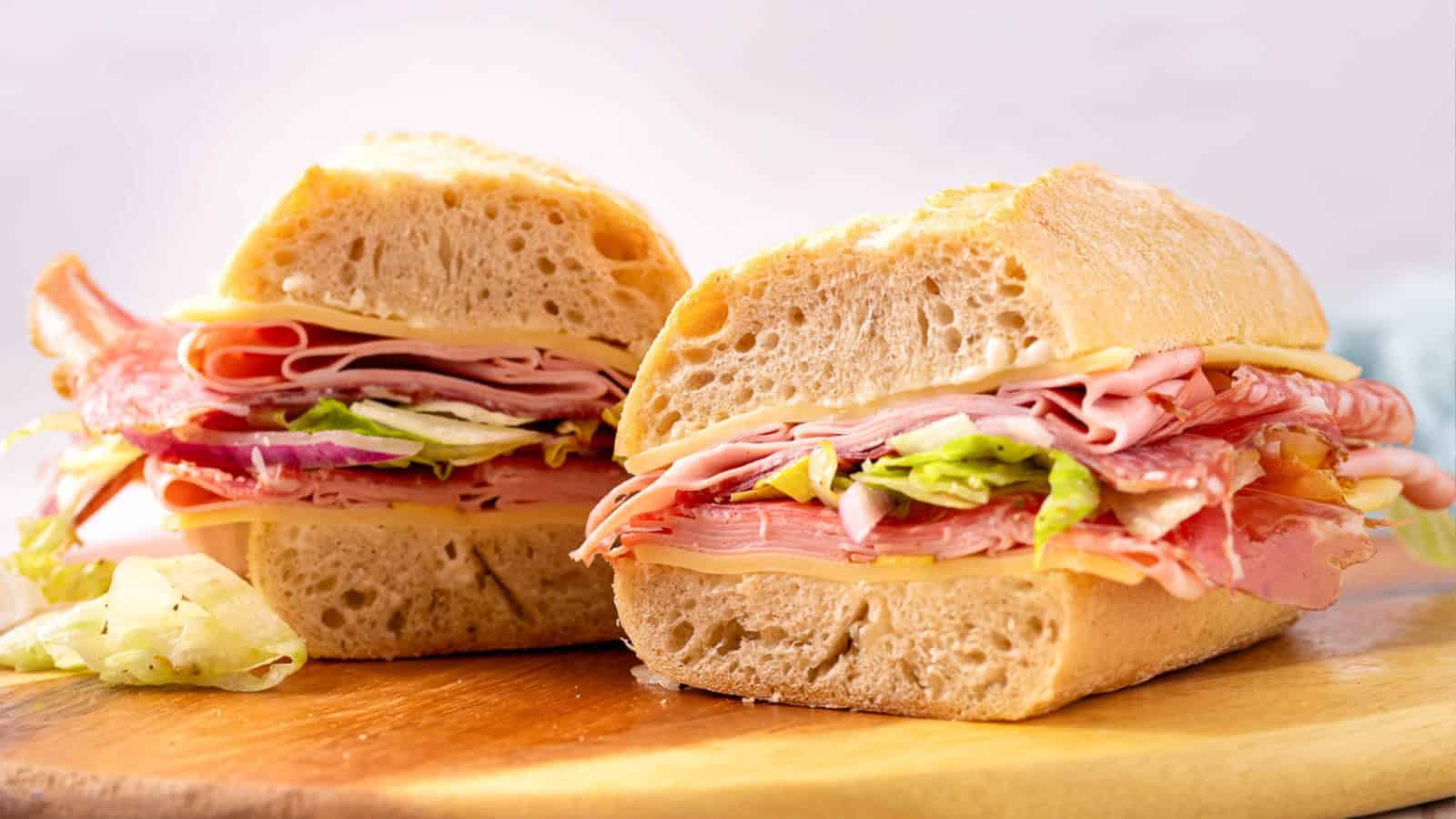 A finished grinder sandwich is shown on a marble platter.