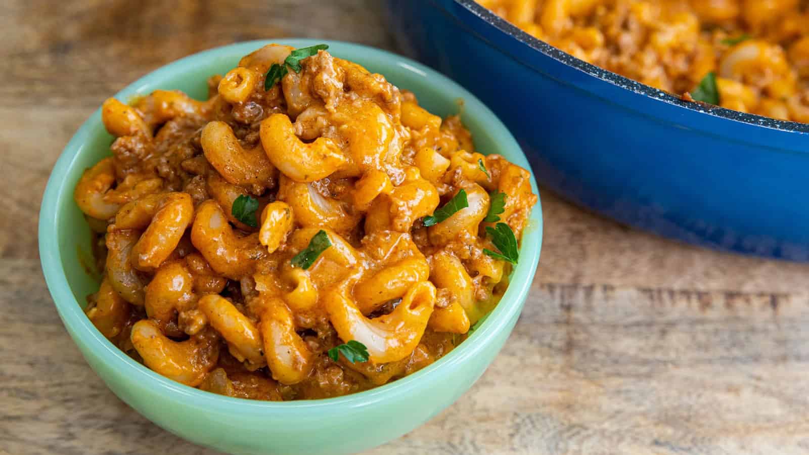 Homemade hamburger helper with ground beef and pasta in a skillet.