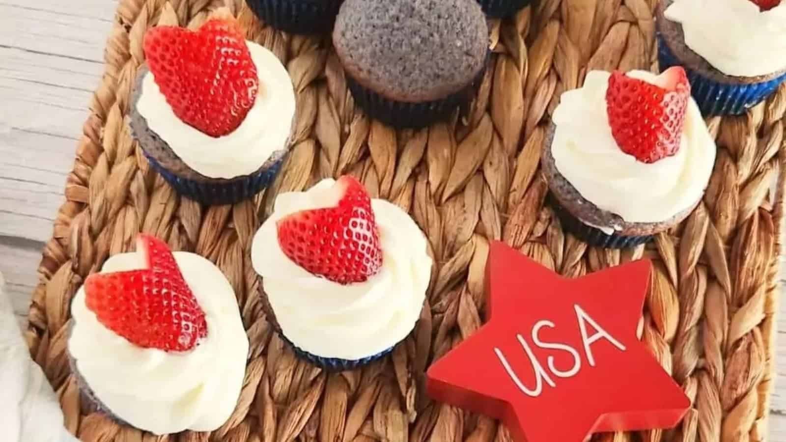 Mini cupcakes with white frosting and strawberry halves, next to a red star labeled