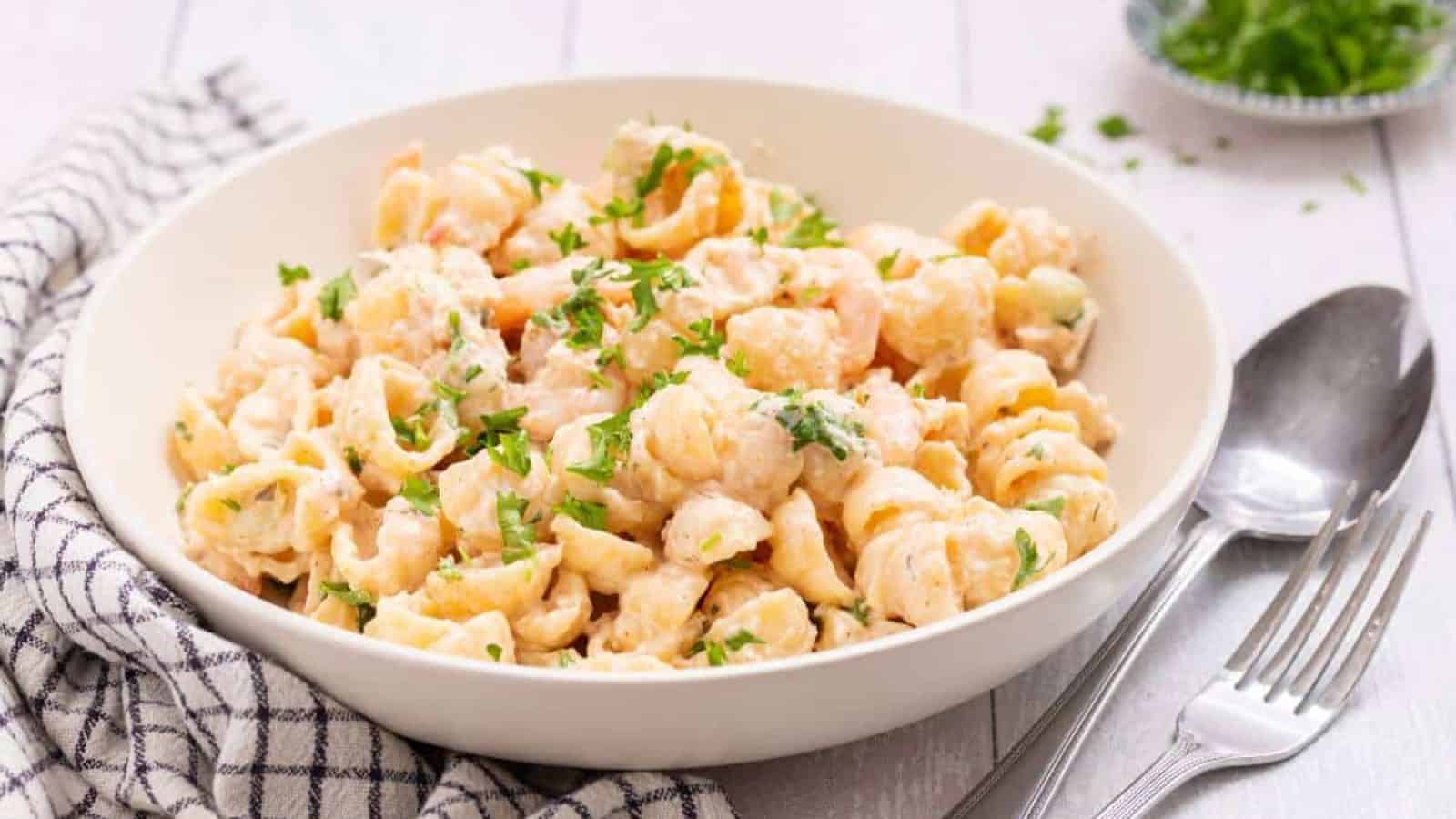Seafood pasta salad in white serving bowl.