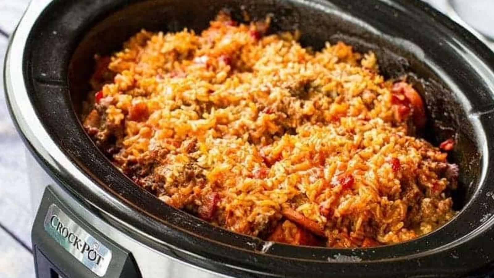 Close-up of a Crock-Pot filled with cooked rice, ground beef, and tomato sauce.